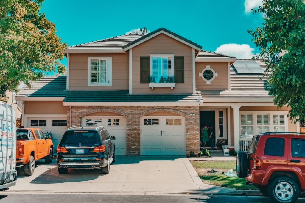 Suburban family house with cars parked in the driveway