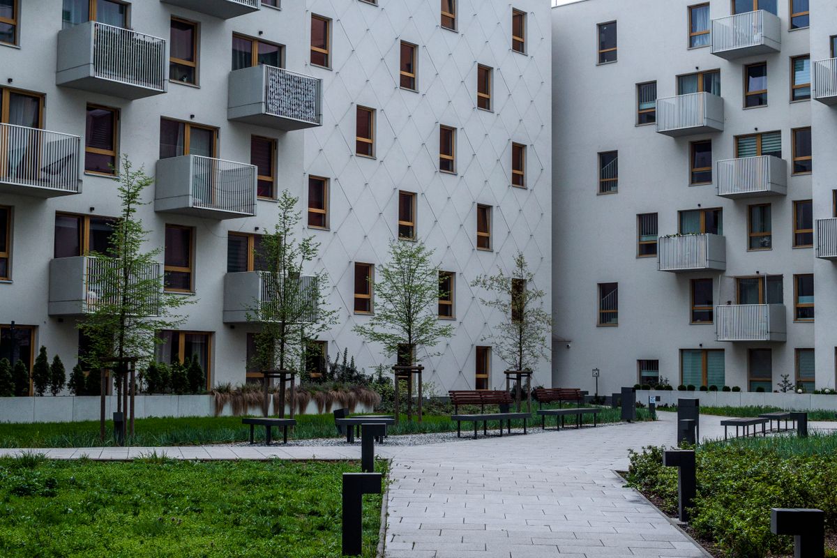 Apartment and condo building with balconies around a landscaped courtyard