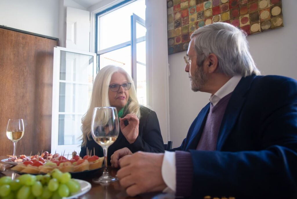 Older couple sharing a meal and conversation at a restaurant table