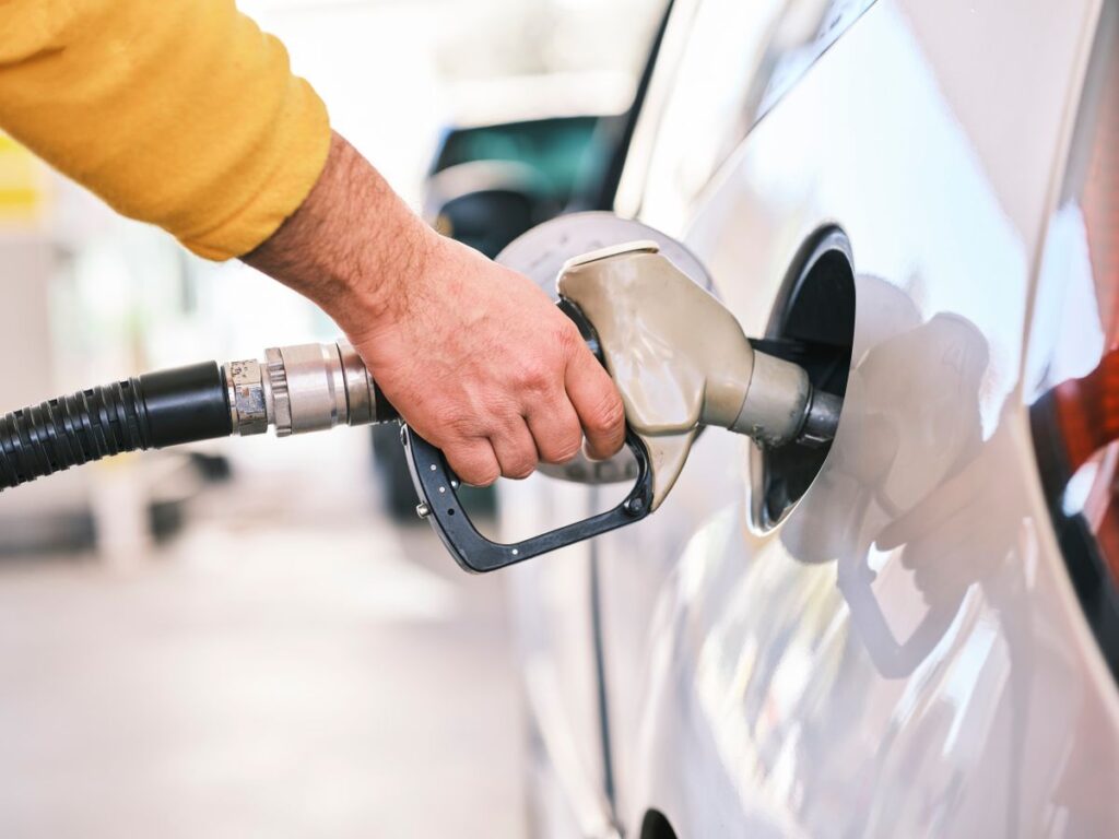 Fuel Rewards and Car Maintenance With Member Savings for Drivers Driver filling up a white car with fuel at the pump