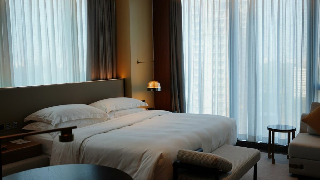 Premium hotel room with a king bed and floor-to-ceiling windows