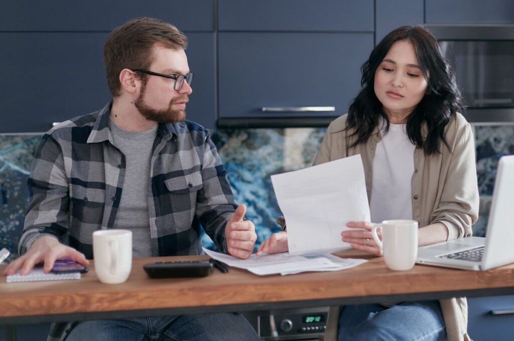 Home Equity Lines of Credit With an Online Application and No Appraisal Couple reviewing paperwork with a laptop at the kitchen table