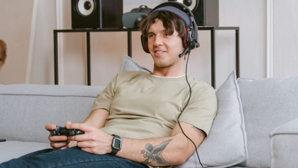 In-Game Points for EA Sports FC 27, Call of Duty and Apex Legends on Xbox Young man with a headset enjoying a gaming session on the sofa