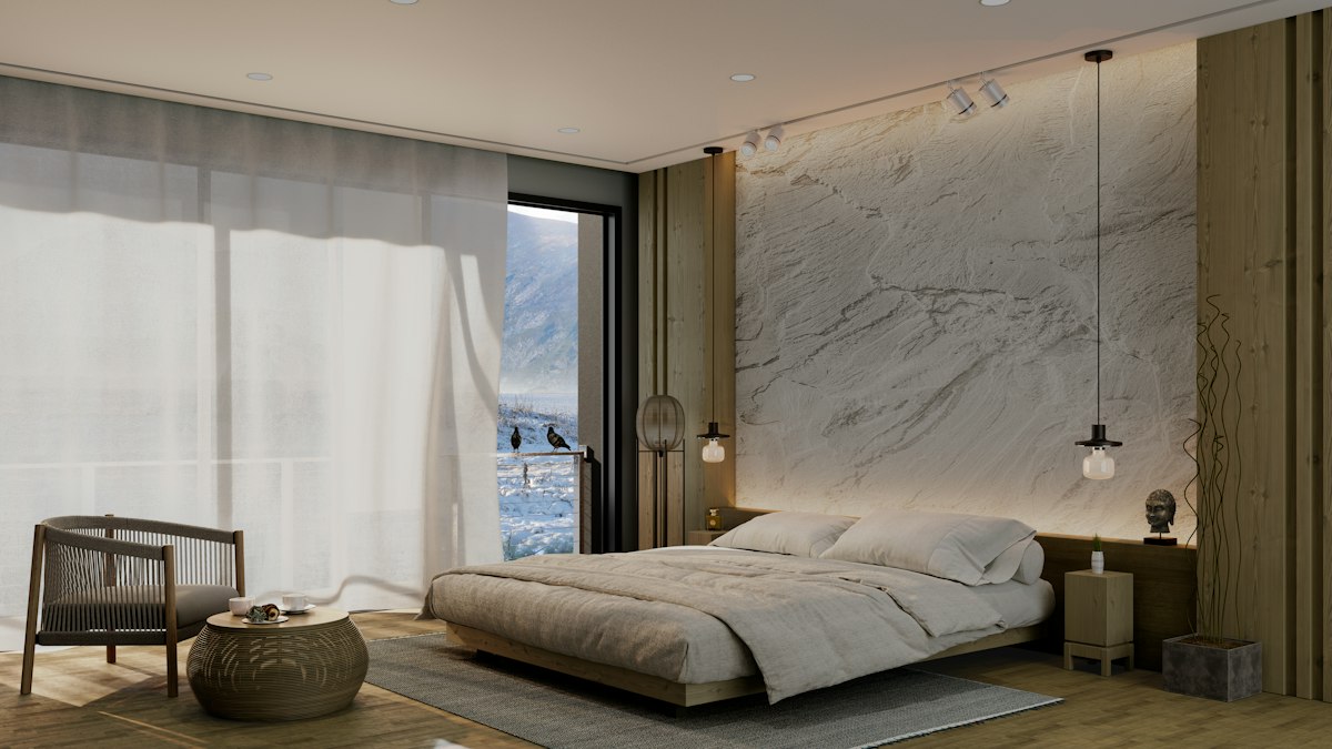 Modern hotel bedroom with a marble accent wall and a window onto snowy mountains