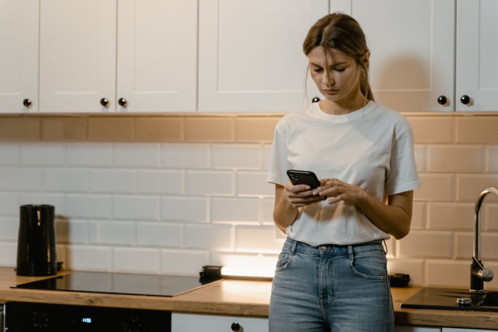 Checking a prepaid plan on a phone in a kitchen