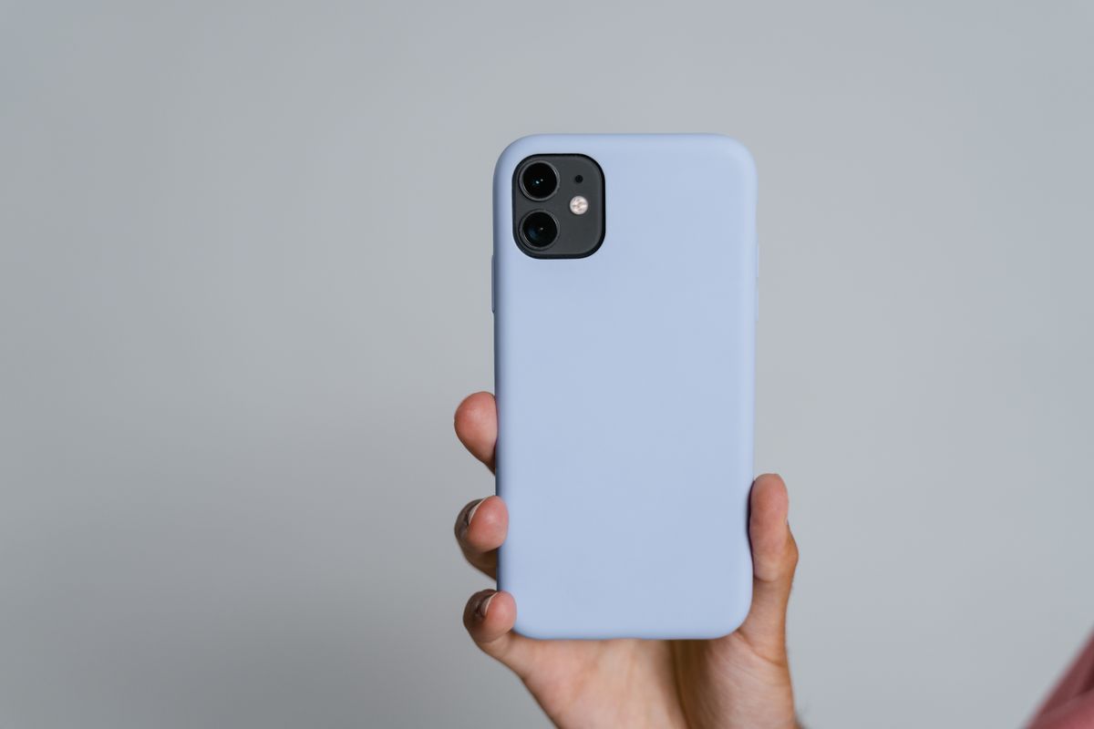 A phone held up against a plain background