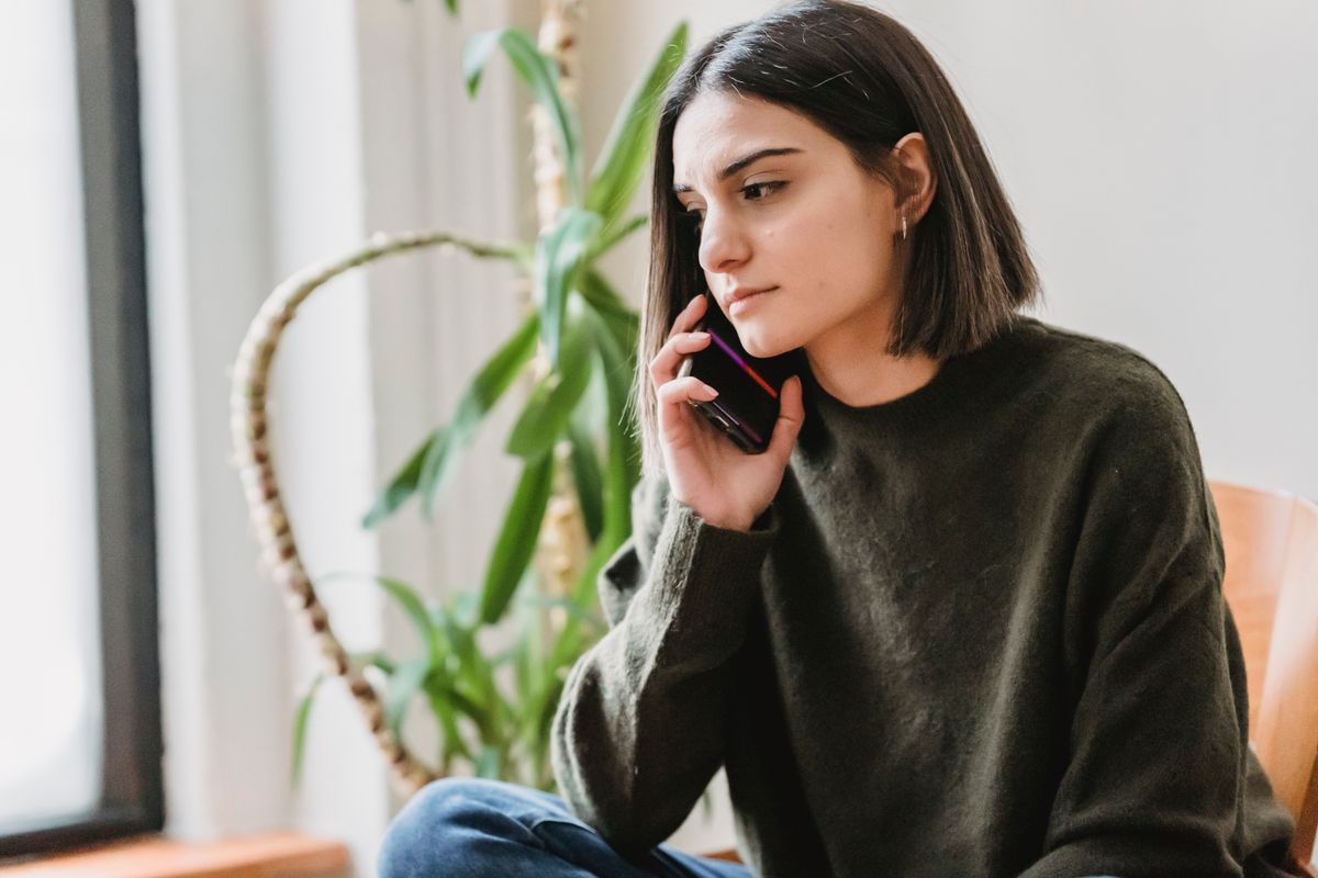 A woman on a phone call at home