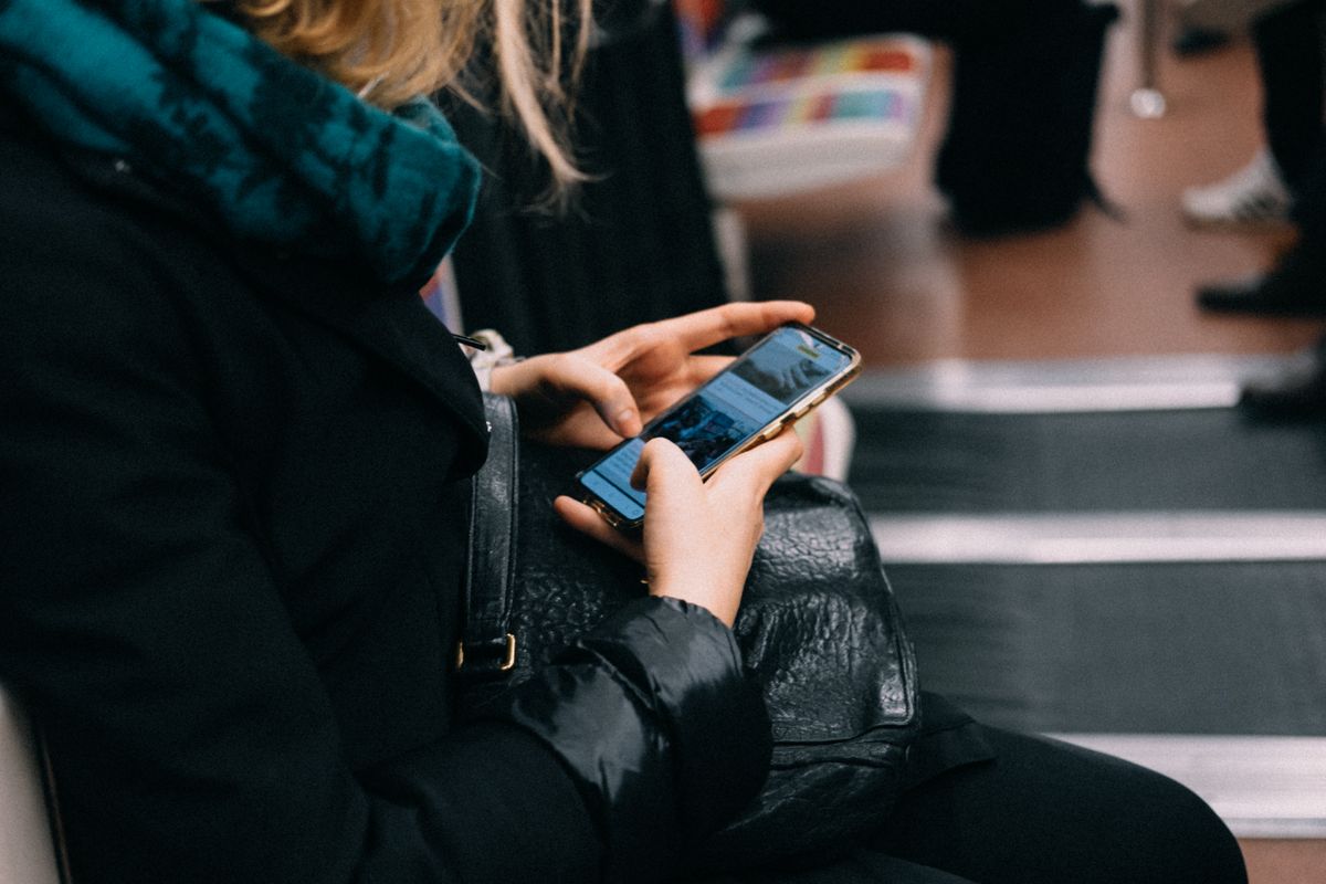 A woman using her phone on a train