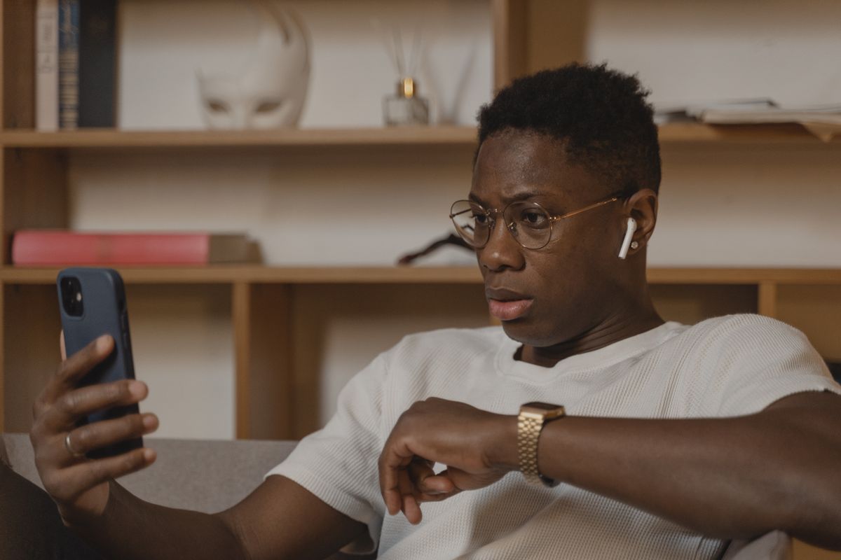 A man on a video call wearing wireless earphones