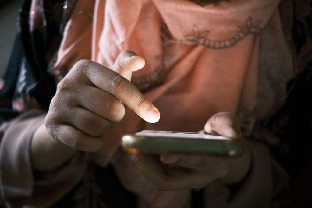 A finger scrolling a phone screen