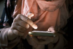 A finger scrolling a phone screen