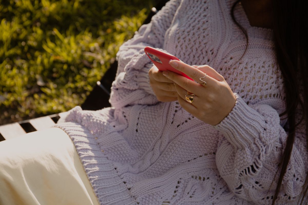 A woman using her phone outdoors