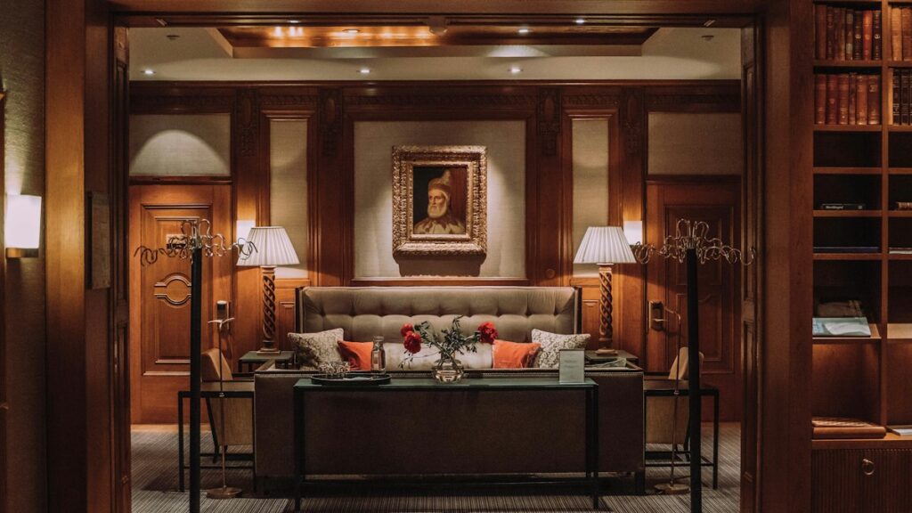 Malmö Hotels for a Weekend With a Day Trip to Copenhagen Classic hotel suite with wood panelling, bookshelves and a sofa