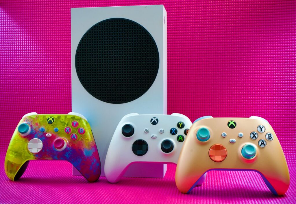 Xbox Series S console with three colourful wireless controllers