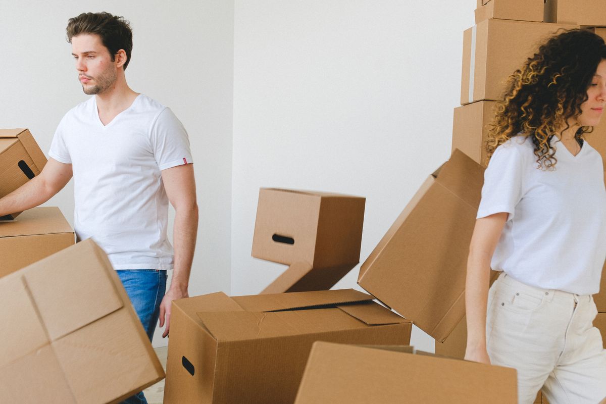 Couple unpacking moving boxes in a new apartment