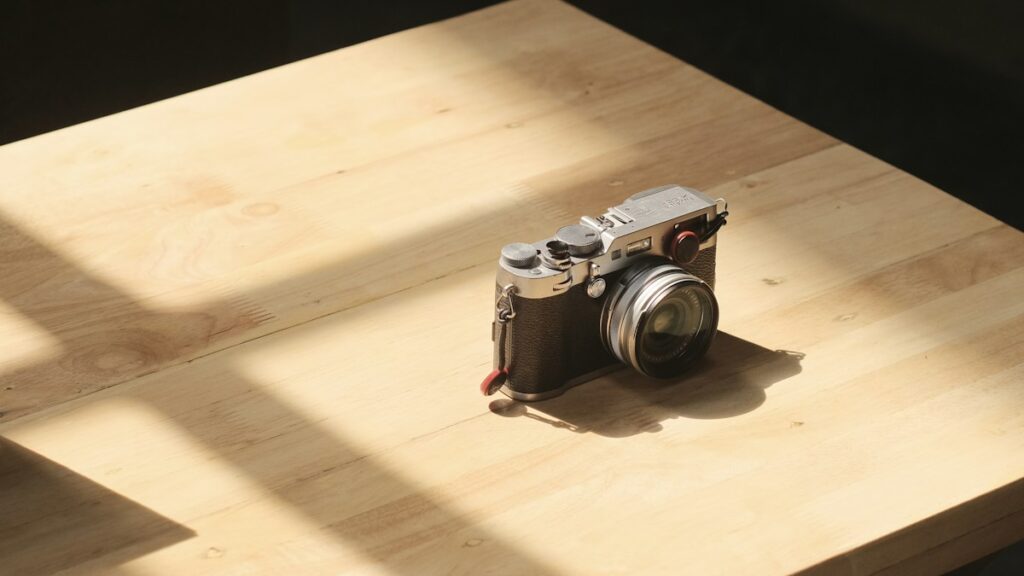 A compact camera on a wooden table